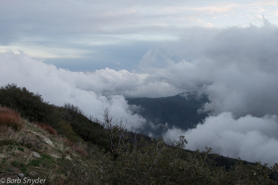 The clouds are lying in the valley below. The light blue color at about 11 on the photo was such a beautiful hue, it was quite dark before I came down the mountain.