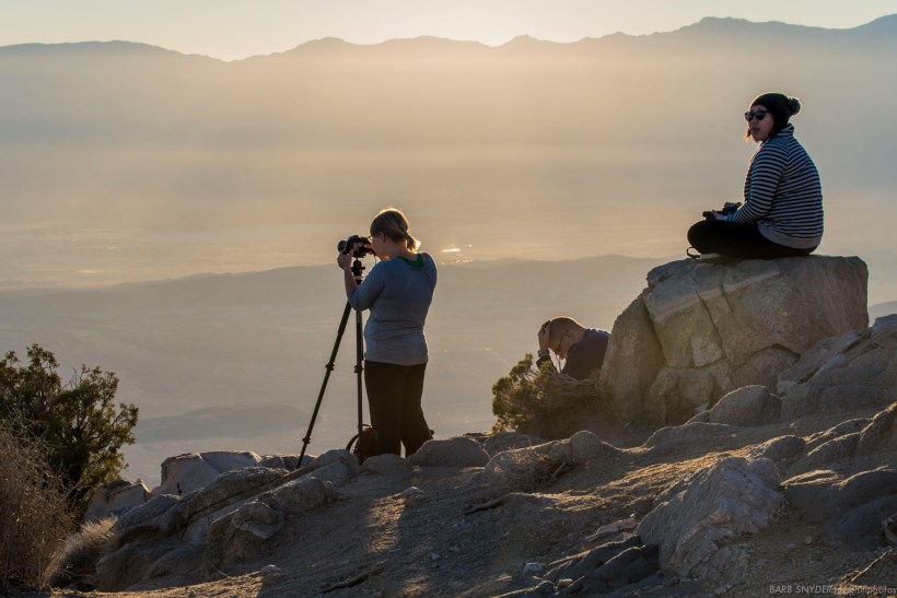 Lots of photographers, people playing cards, coolers of refreshment.